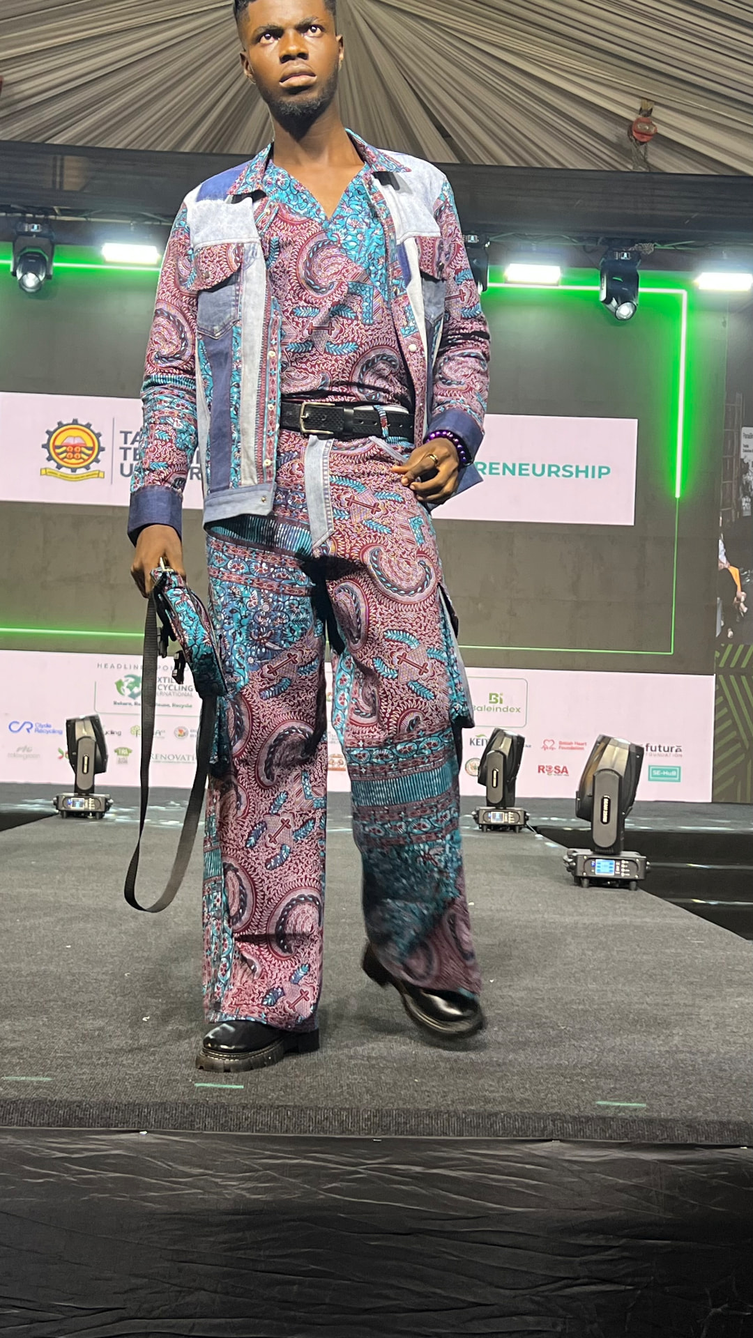 Model on the L2L Summit runway wearing an upcycled paisley co-ord with reclaimed denim panels.