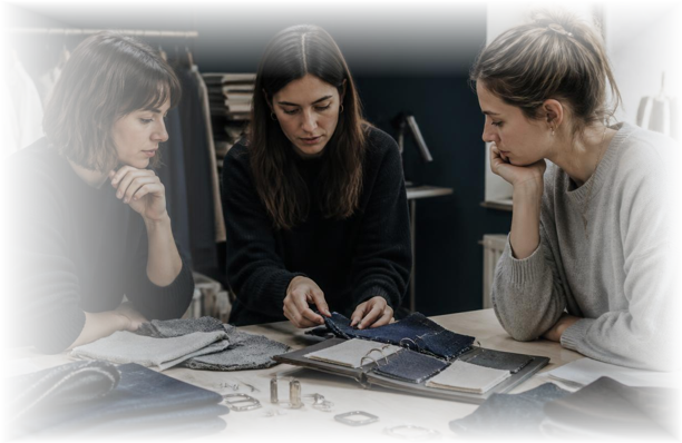 Fashion team reviewing fabric swatches and jewellery samples around a table
