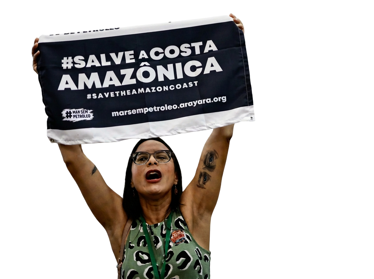 A campaigner holds a banner reading '#SALVE A COSTA AMAZÔNICA' calling for Amazon rainforest protection
